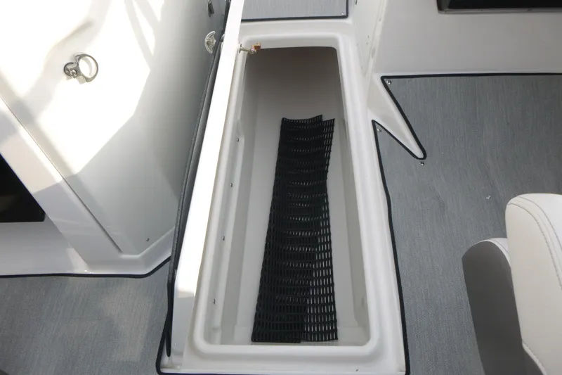 Slide: The Image of 2026 Yamaha AR250 boat storage compartment with black mat, gray flooring. - 7