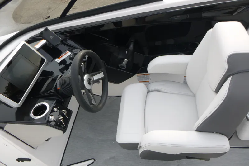 Slide: The Image of 2026 Yamaha Boats AR250 cockpit with steering wheel, touchscreen, and plush captain's chair. - 9