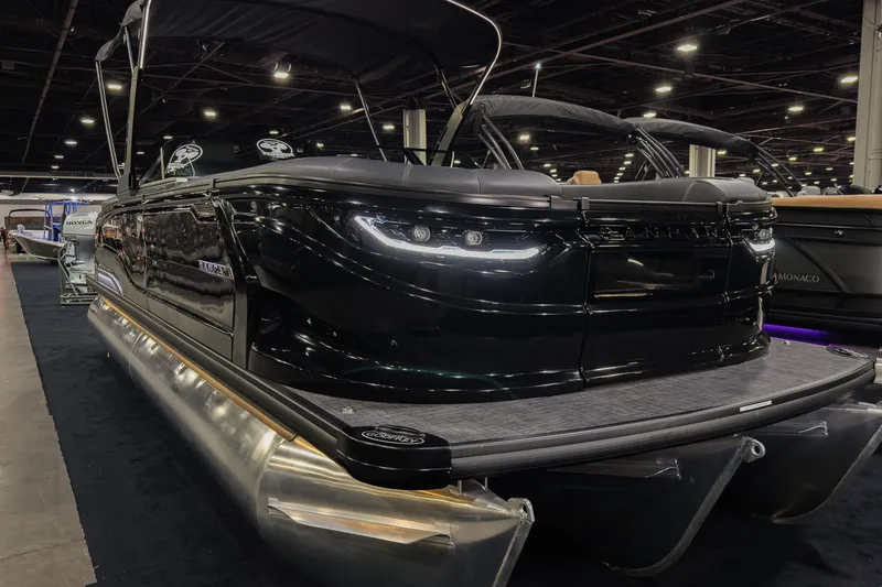 The Image of 2026 Godfrey SanPan 25' Split Bench Windshield pontoon boat displayed indoors. - 0