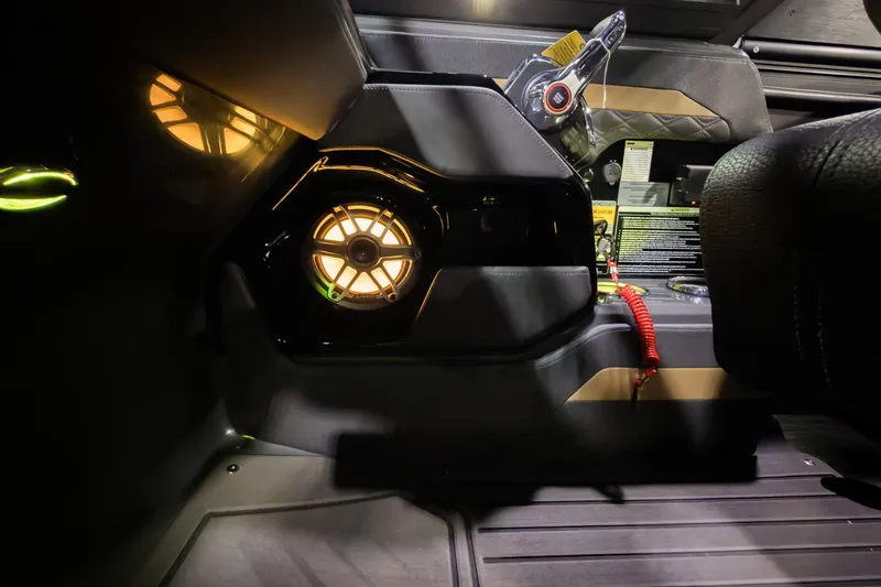 Slide: The Image of Interior view of 2026 Godfrey SanPan 25' Split Bench Windshield, featuring illuminated speaker and controls. - 19