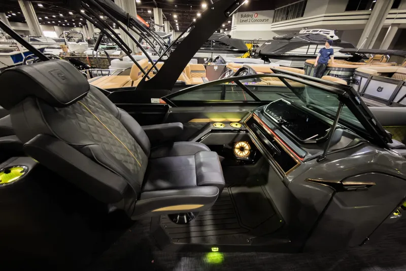 Slide: The Image of Luxurious interior of 2026 Godfrey SanPan 25' Split Bench Windshield boat at a showroom. - 23
