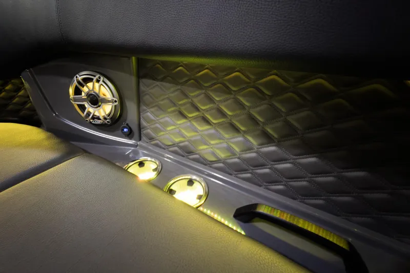 Slide: The Image of Luxurious interior of 2026 Godfrey SanPan 25' with illuminated speaker and quilted paneling. - 9