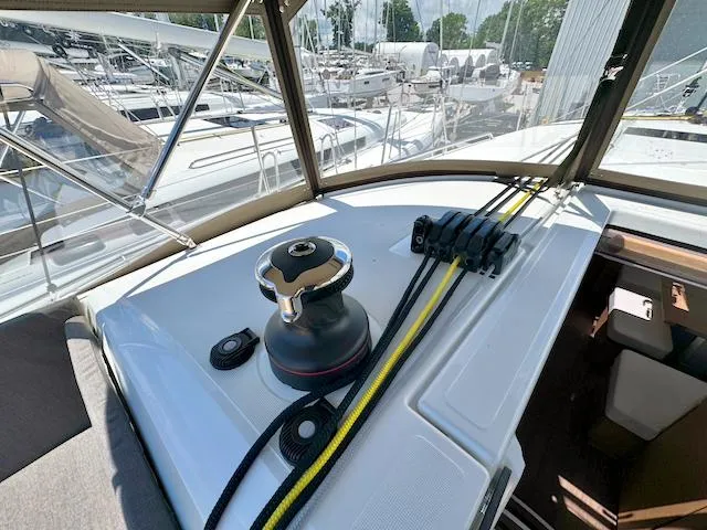 Slide: The Image of Jeanneau Sun Odyssey 490 cockpit with winch and ropes, 2023 model, docked in marina. - 11