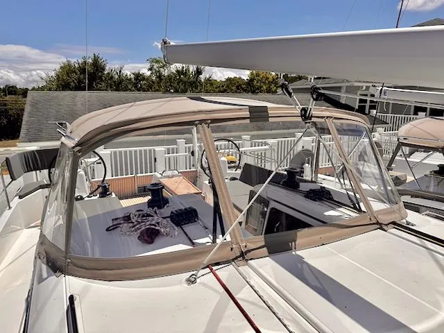 Slide: The Image of 2023 Jeanneau Sun Odyssey 490 sailboat with beige canopy and clear windows. - 20