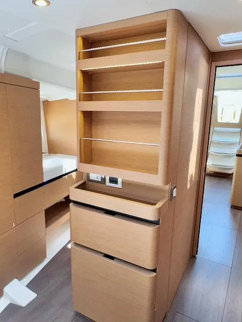 Slide: The Image of Interior of 2023 Jeanneau Sun Odyssey 490 yacht with modern wooden cabinetry. - 29