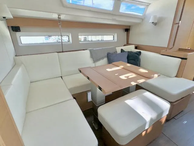 Slide: The Image of Interior of 2023 Jeanneau Sun Odyssey 490, featuring a modern, spacious seating area. - 32
