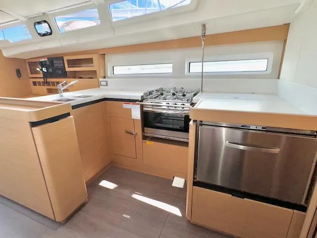 Slide: The Image of Modern kitchen in 2023 Jeanneau Sun Odyssey 490 yacht with sleek appliances and ample counter space. - 33