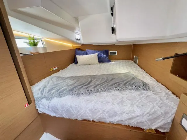 Slide: The Image of Cozy cabin interior of 2023 Jeanneau Sun Odyssey 490 yacht with modern bedding. - 36