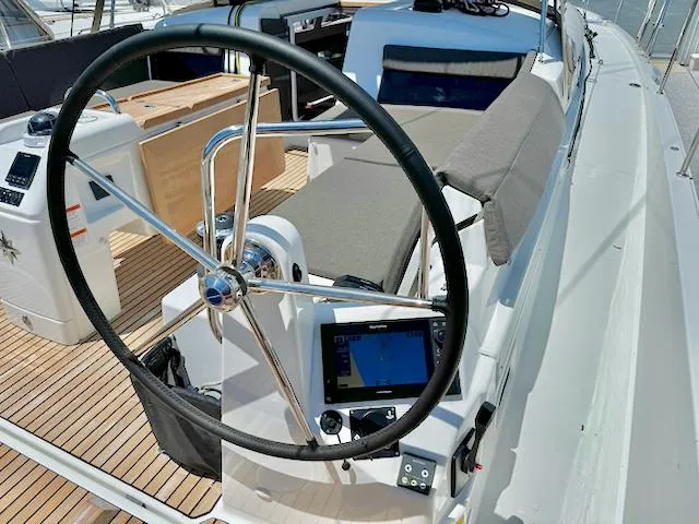 Slide: The Image of 2023 Jeanneau Sun Odyssey 490 yacht cockpit with steering wheel and navigation system. - 4