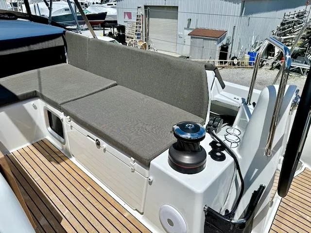Slide: The Image of Jeanneau Sun Odyssey 490, 2023 model, featuring a spacious deck with cushioned seating. - 7