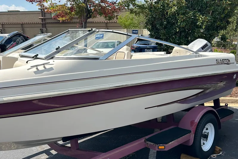 Slide: The Image of 1999 Glastron GS185 SF boat on trailer, white and maroon color scheme. - 0