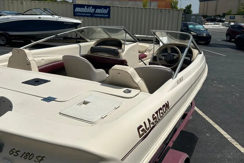 Slide: The Image of 1999 Glastron GS185 SF boat with open cockpit, parked outdoors. - 2