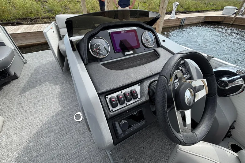 Slide: The Image of 2025 Godfrey MC235SDB boat dashboard with steering wheel and control panel. - 8