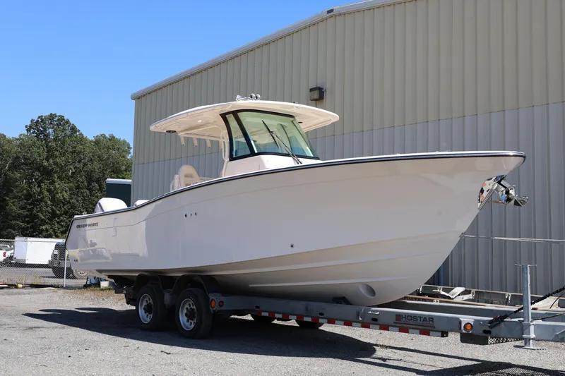 Slide: The Image of 2026 Grady-White Canyon 306 boat on trailer, parked outdoors near a building. - 4
