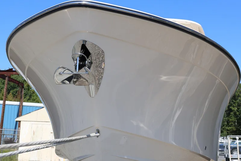 Slide: The Image of 2026 Grady-White Canyon 306 boat bow with anchor, clear sky background. - 5
