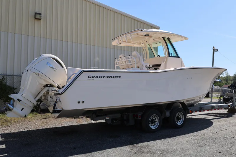 Slide: The Image of 2026 Grady-White Canyon 306 boat on trailer, parked outdoors. - 6