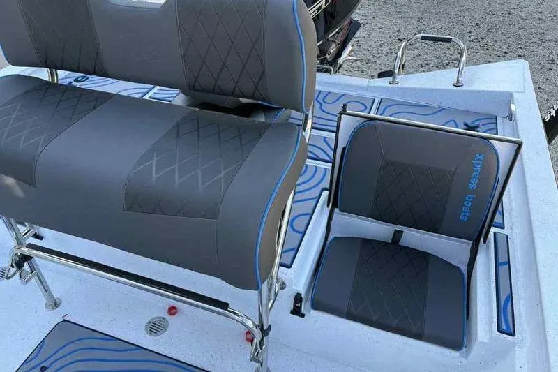 Slide: The Image of 2026 Xpress H20B Bay boat seats with blue accents and diamond stitching. - 10