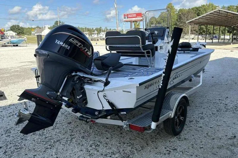 Slide: The Image of 2026 Xpress H20B Bay boat with Yamaha engine on trailer in outdoor setting. - 14