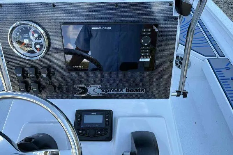 Slide: The Image of 2026 Xpress H20B Bay boat dashboard with steering wheel, gauges, and electronic display. - 17