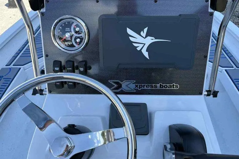 Slide: The Image of Steering console of 2026 Xpress H20B Bay boat with logo and gauges. - 18