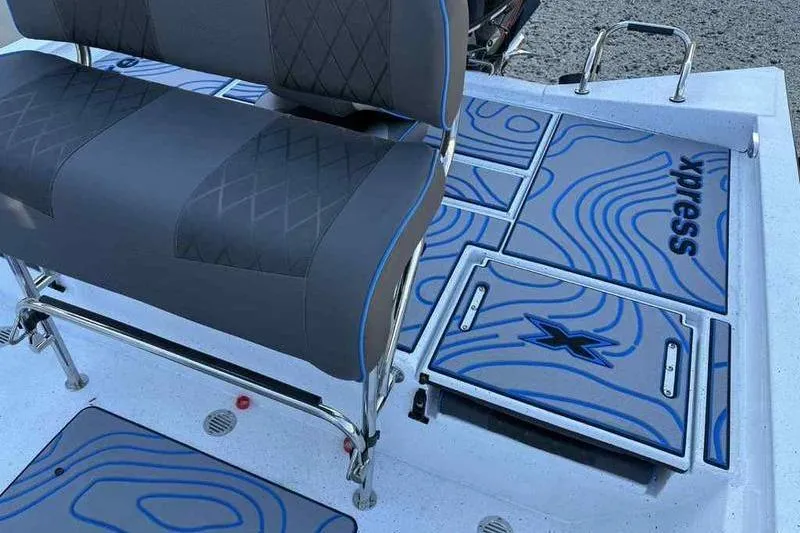 Slide: The Image of 2026 Xpress H20B Bay boat interior with patterned seating and deck design. - 19