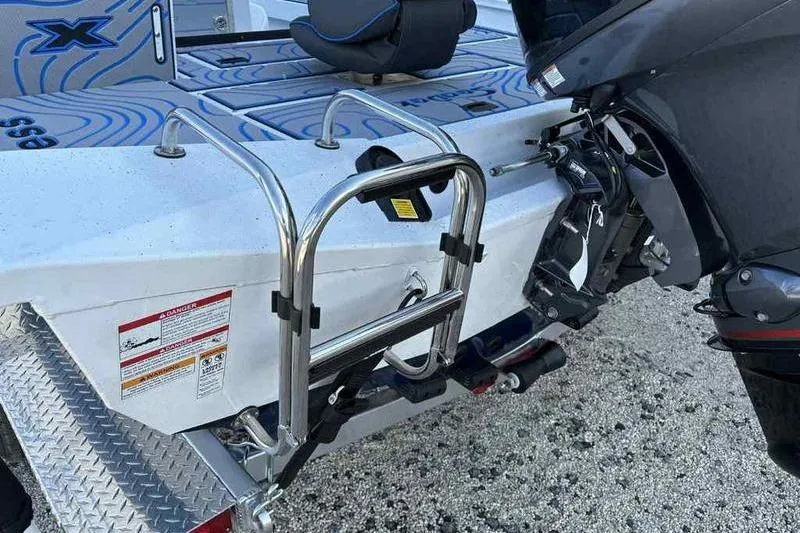 Slide: The Image of 2026 Xpress H20B Bay boat with motor and ladder on trailer. - 7