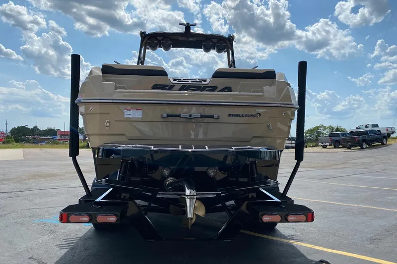 Slide: The Image of 2023 Supra SE450 boat rear view under a cloudy sky. - 3