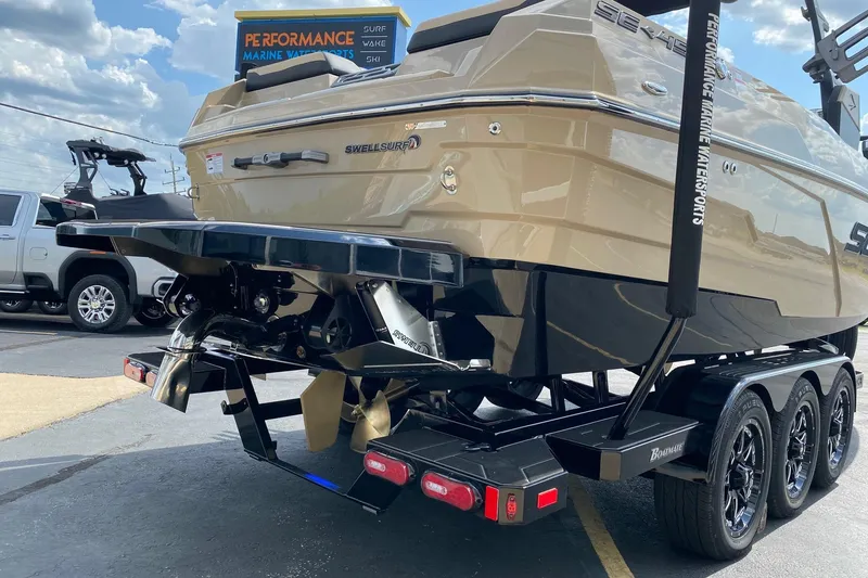 Slide: The Image of 2023 Supra SE450 boat on trailer, featuring SwellSurf system and triple-axle wheels. - 4