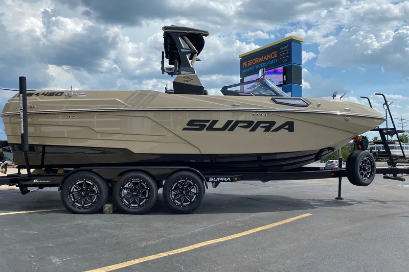 Slide: The Image of 2023 Supra SE450 boat on trailer at Performance Marine Watersports dealership. - 5