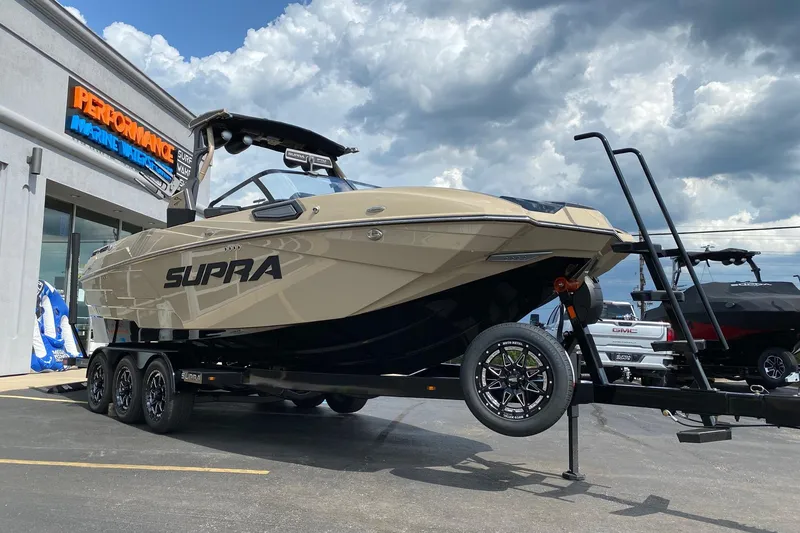 Slide: The Image of 2023 Supra SE450 boat on trailer at Performance Marine dealership. - 6