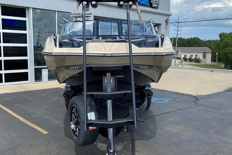 Slide: The Image of 2023 Supra SE450 boat on trailer outside dealership, front view. - 7