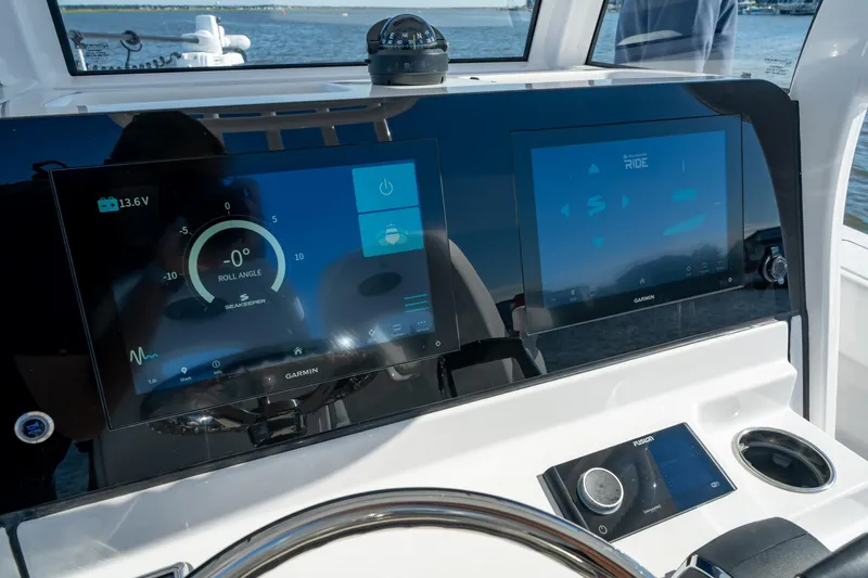 Slide: The Image of 2024 Sportsman Heritage 261 Center Console dashboard with dual Garmin displays. - 10