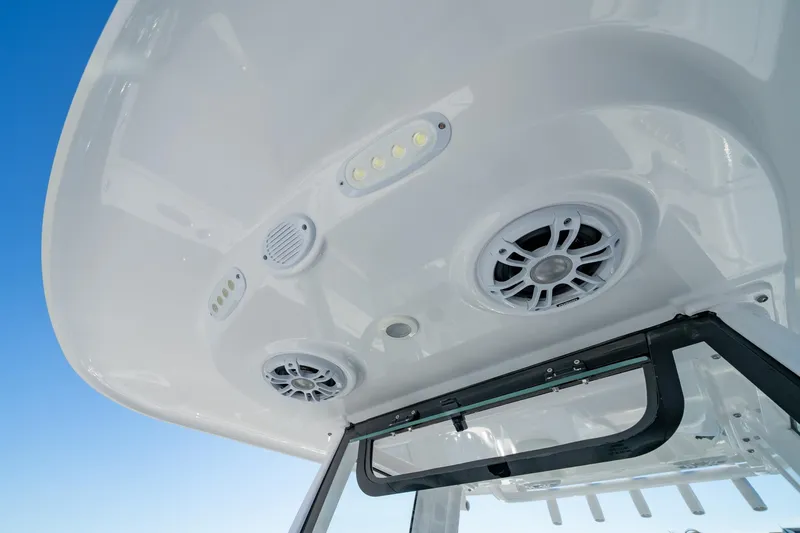 Slide: The Image of 2024 Sportsman Heritage 261 Center Console boat speakers and lights on T-top. - 13