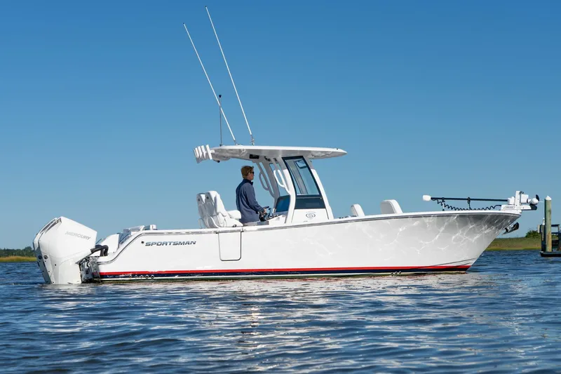 Slide: The Image of 2024 Sportsman Heritage 261 Center Console boat on calm water, side view. - 17