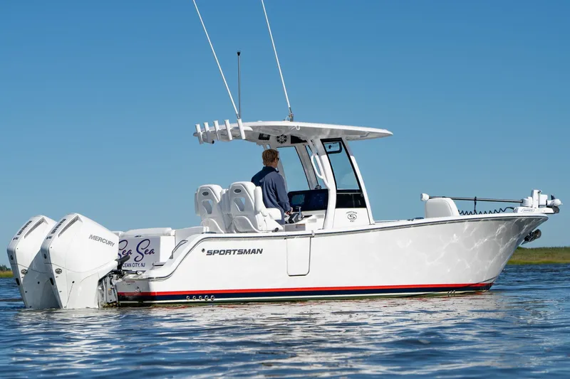 Slide: The Image of 2024 Sportsman Heritage 261 Center Console boat on water, featuring dual Mercury engines. - 2