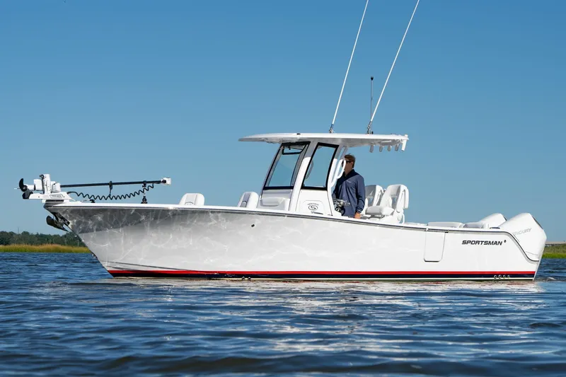 Slide: The Image of 2024 Sportsman Heritage 261 Center Console boat on calm water, clear blue sky. - 4