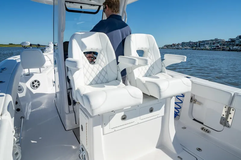 Slide: The Image of 2024 Sportsman Heritage 261 Center Console boat interior with luxurious white seating. - 6