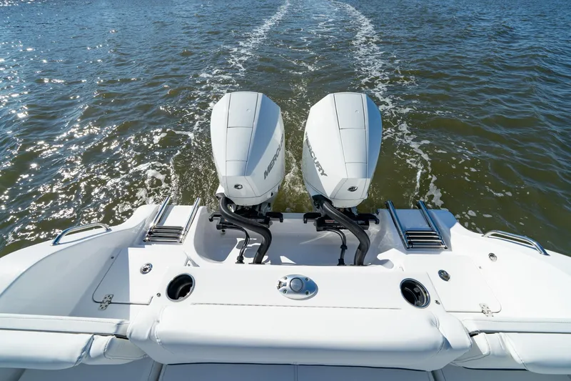 Slide: The Image of 2024 Sportsman Heritage 261 Center Console with dual Mercury outboard engines on water. - 7
