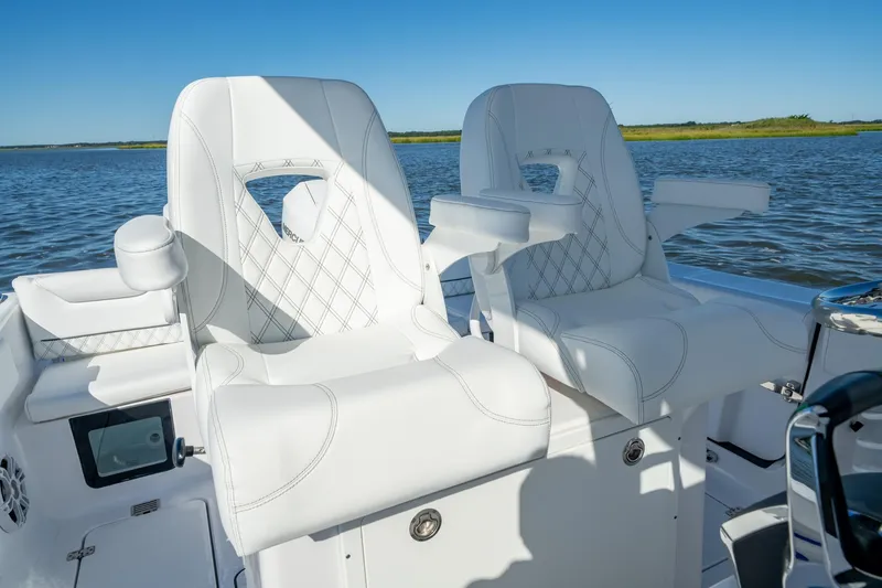 Slide: The Image of 2024 Sportsman Heritage 261 Center Console boat with luxurious white seating. - 8