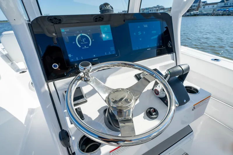 Slide: The Image of 2024 Sportsman Heritage 261 Center Console helm with dual displays and steering wheel. - 9