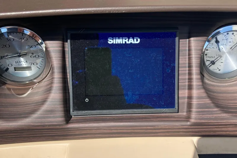 Slide: The Image of 2018 Bennington 23 SX boat seat with cup holder, featuring beige upholstery and diamond-patterned backrest. - 18