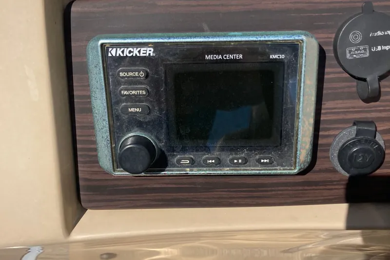 Slide: The Image of Bennington 23 SX 2018 boat interior with cup holders and speaker on deck. - 19