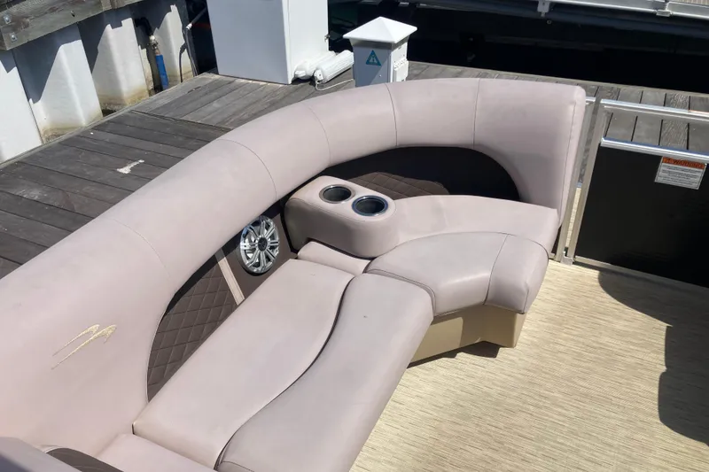 Slide: The Image of Luxurious seating on a 2018 Bennington 23 SX boat, featuring cup holders and premium upholstery. - 21