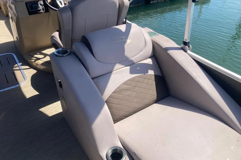 Slide: The Image of 2018 Bennington 23 SX boat interior with comfortable seating and cup holders. - 23