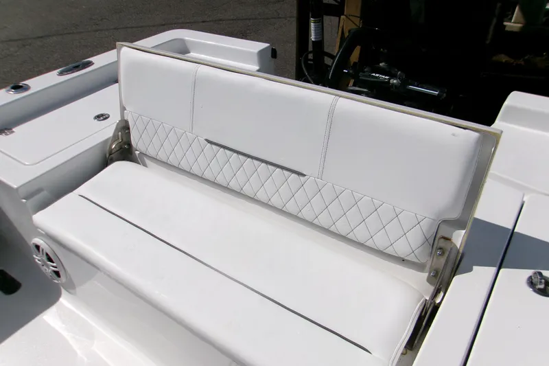 Slide: The Image of 2024 Sportsman Masters 227 Bay Boat with white cushioned seating and diamond stitching. - 14