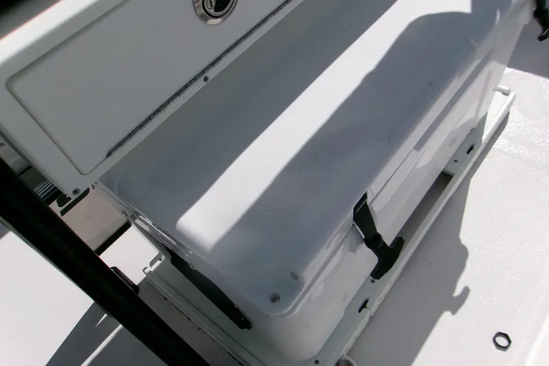 Slide: The Image of 2024 Sportsman Masters 227 Bay Boat cooler storage area with secure latch. - 5
