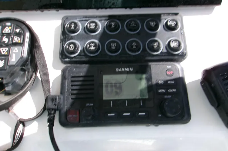 Slide: The Image of Control panel and Garmin device on 2024 Sportsman Masters 227 Bay Boat dashboard. - 6