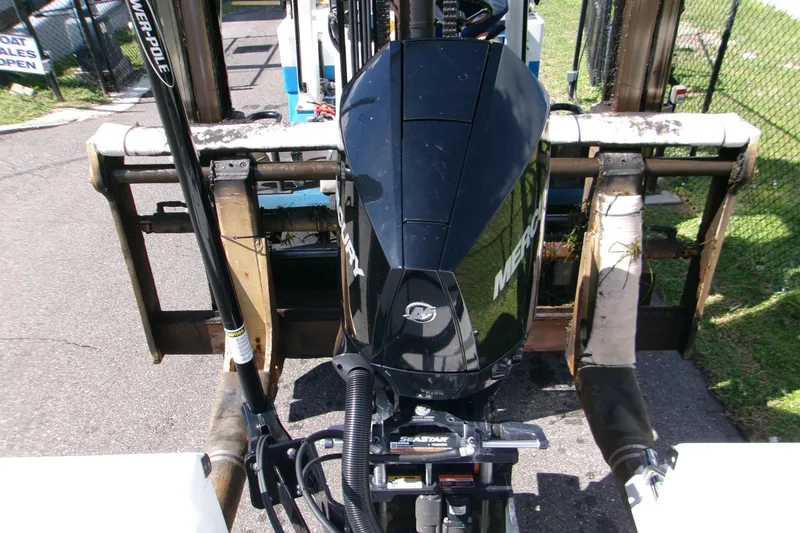 Slide: The Image of 2024 Sportsman Masters 227 Bay Boat with Mercury engine on forklift. - 9