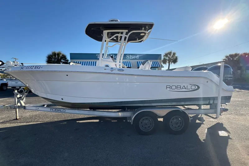 The Image of 2022 Robalo R242 Center Console boat on trailer, sunny day, outdoor display. - 0