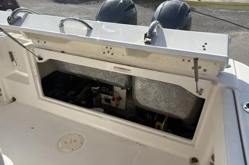 Slide: The Image of 2022 Robalo R242 Center Console storage compartment with Simrad marine electronics. - 13